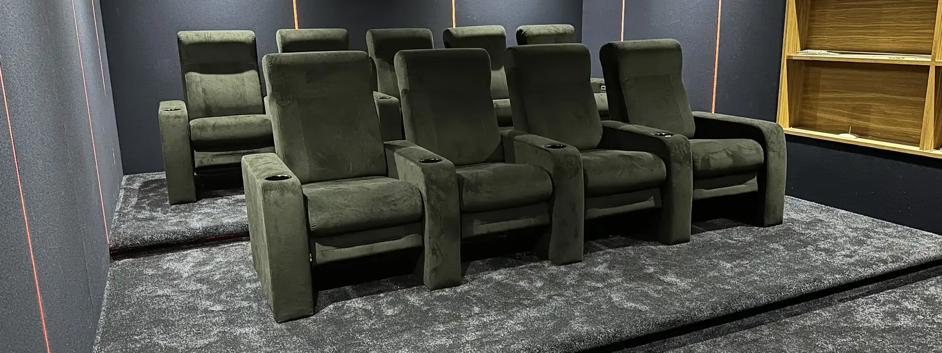AV installation example: two rows of green velvet cinema recliners on a raised tier