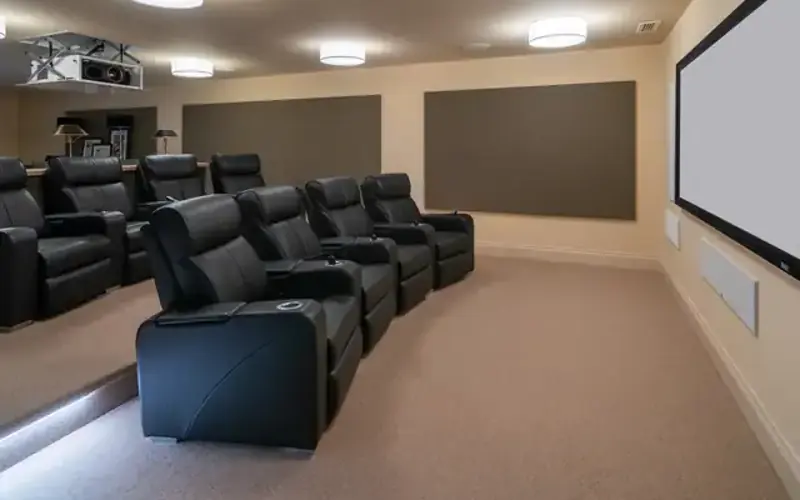 Cinema room with a projector screen and leather recliners
