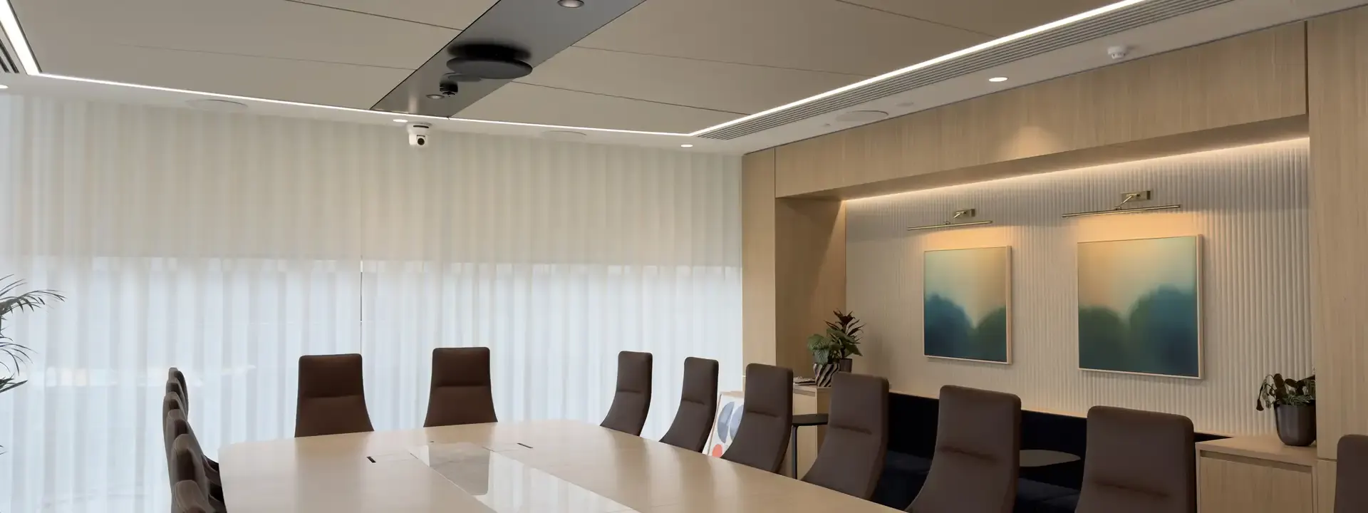 AV installers: meeting room with a long table and ceiling mounted audio above it