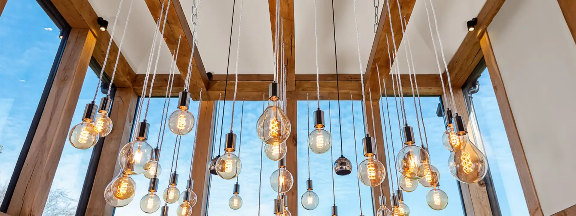 AV installation areas: pendant filament bulbs hanging from an oak framed glass ceiling